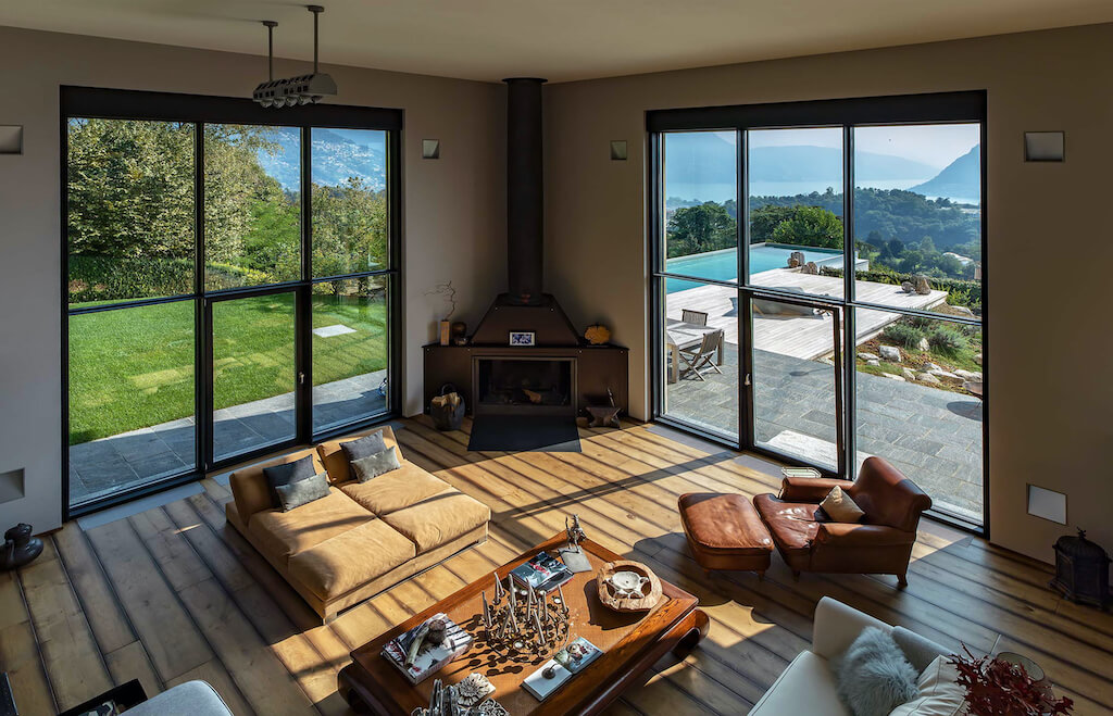  A photo of a living room in a luxury home with floor to ceiling windows overlooking the mountains.