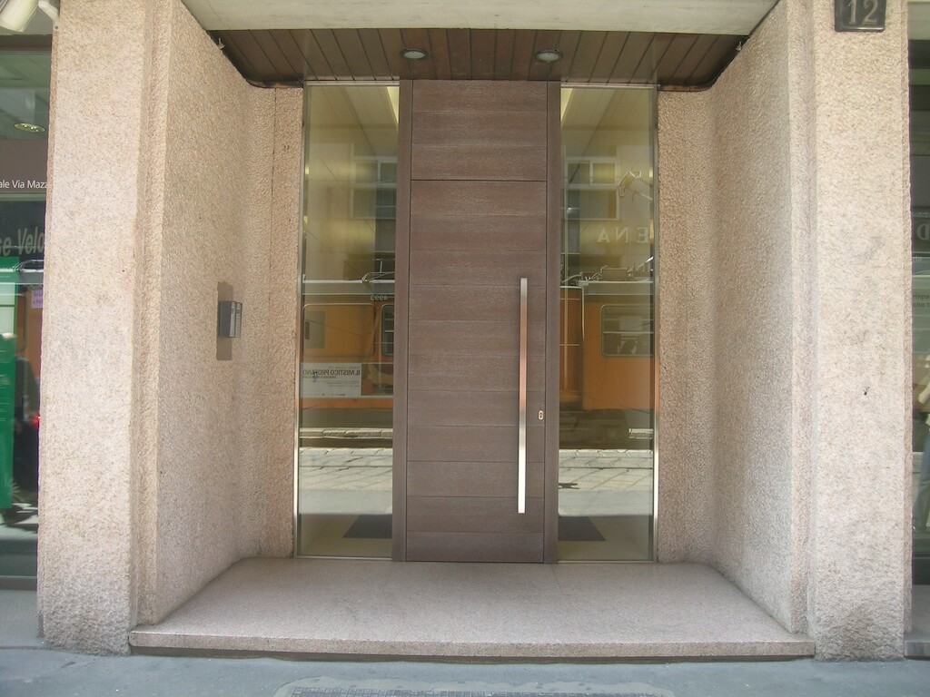 A photo of the security door at the front entrance of a business in a downtown city setting.