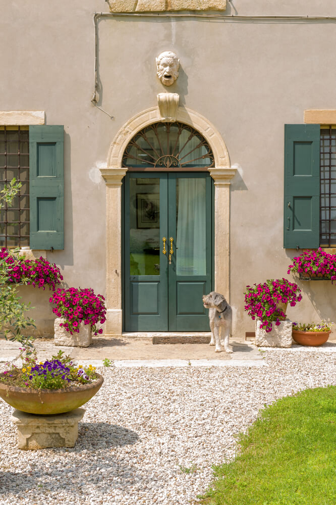 A photo of double custom front doors with glass inserts for an Italian villa.