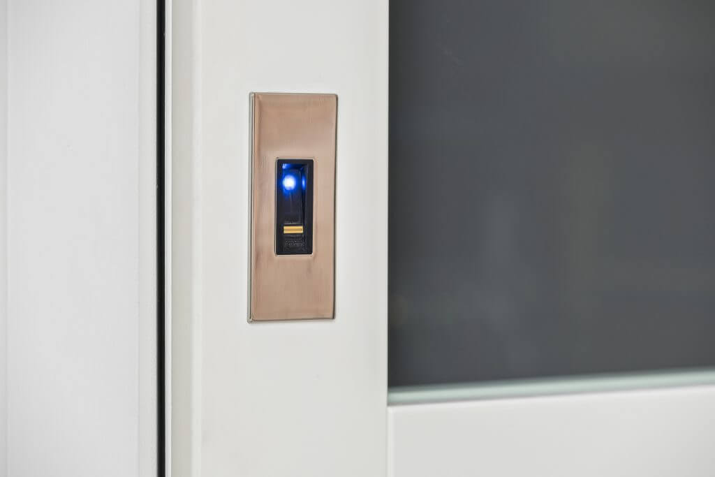 A close-up photo of a fingerprint scan panel on a motorized door.