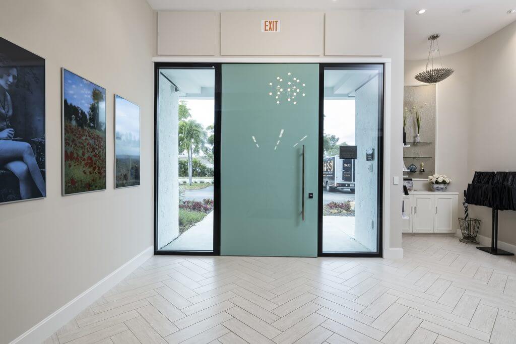 A photo of a custom FBS pivot door at the front entrance of our Florida headquarters.