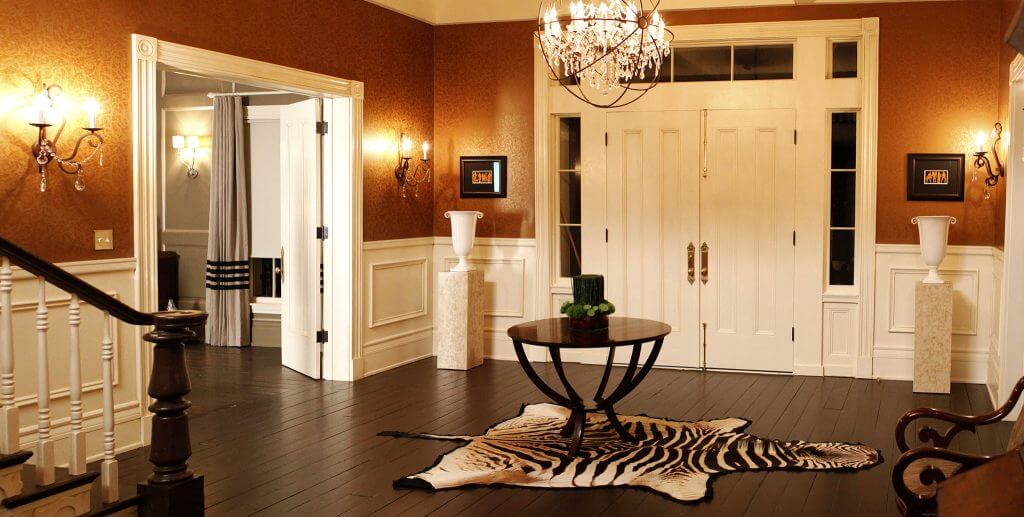 A photo of the interior of the front entrance to a luxury home, complete with a double security door and security windows.