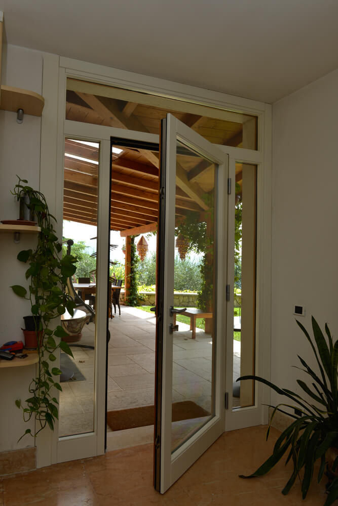  A photo of a glass hurricane certified hinge door opening to a patio.