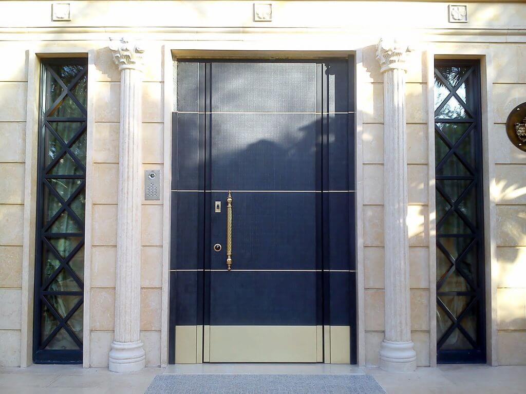 A photo of a steel security door finished with blue panels and gold accents.