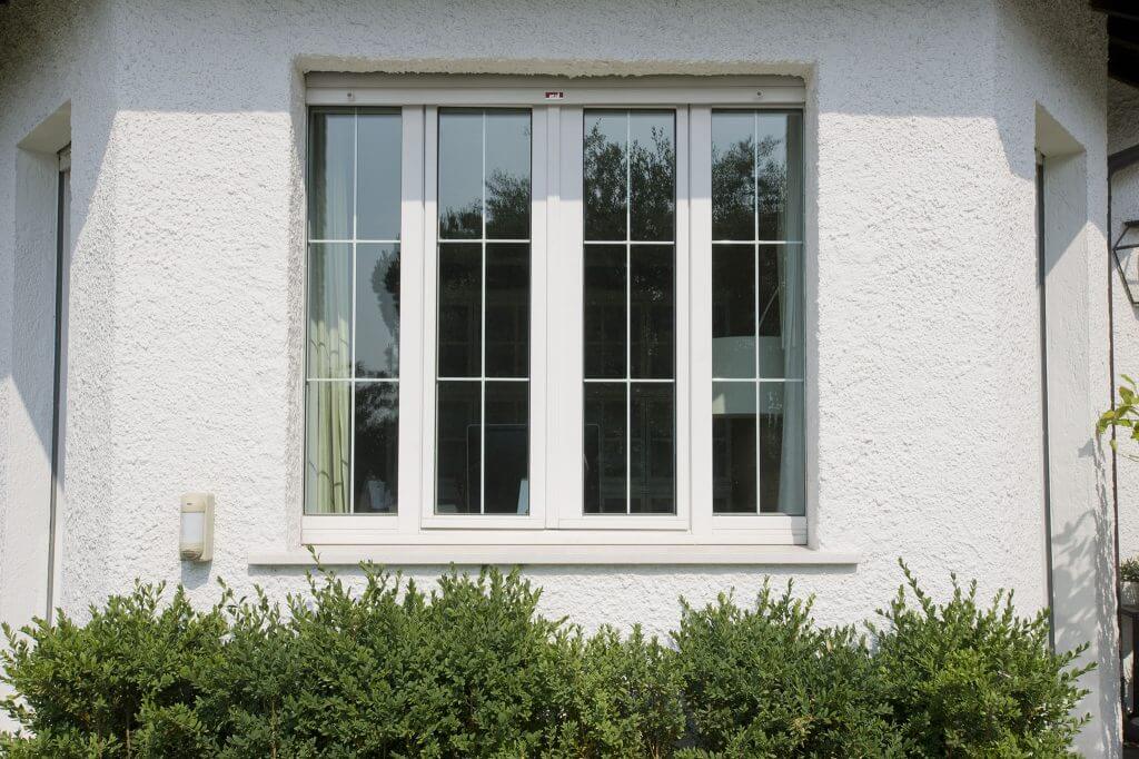 A photo of a hurricane window from the exterior of a house.