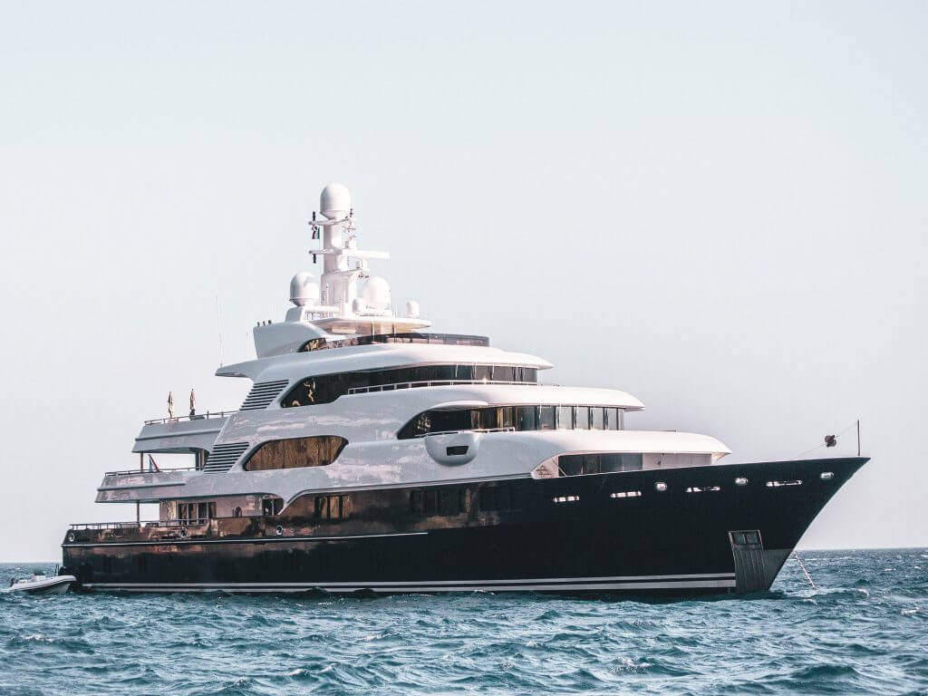 A massive superyacht anchored in the water.