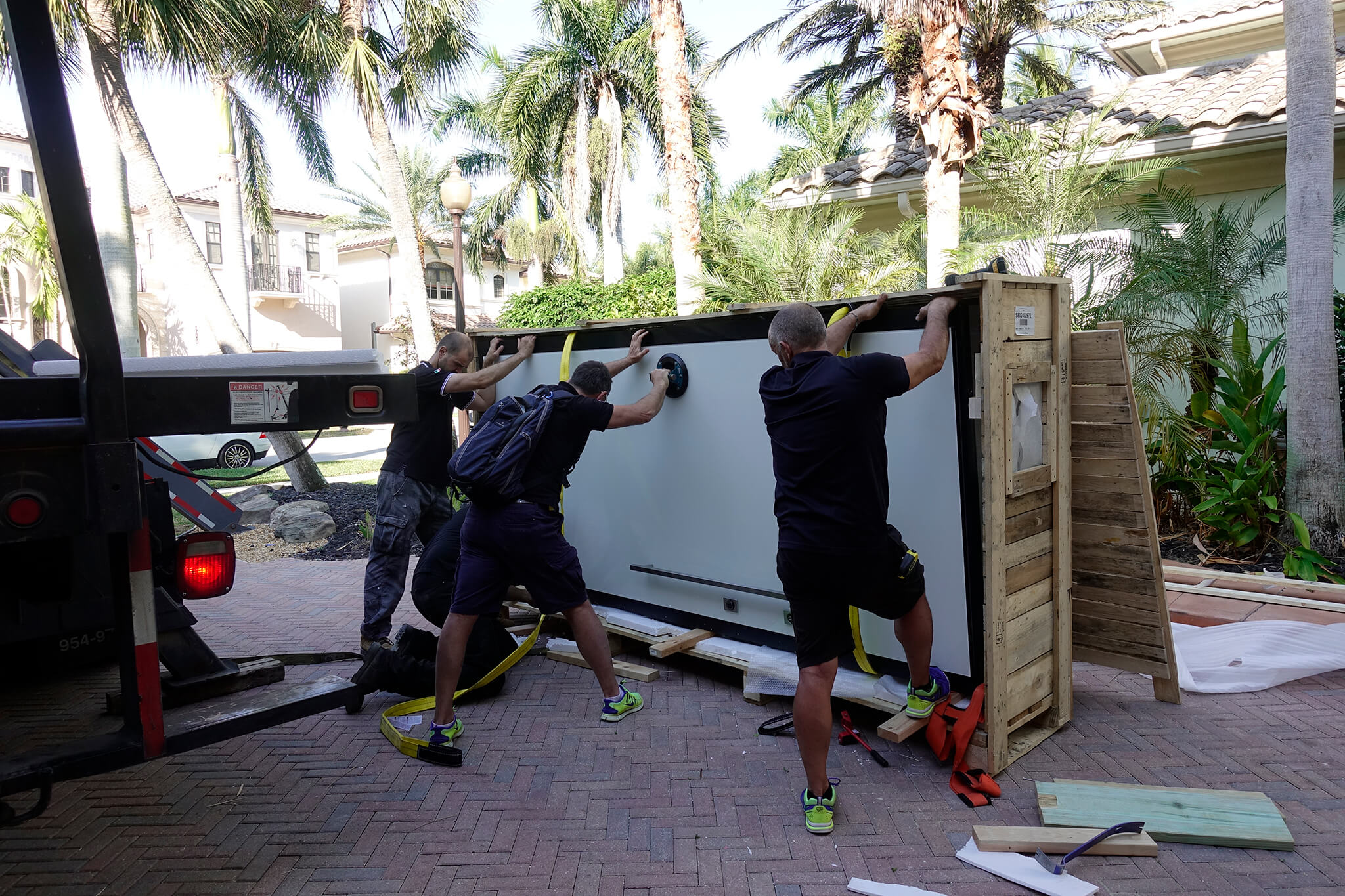 A photo of three contractors uncrating an FBS custom security door at its final destination.