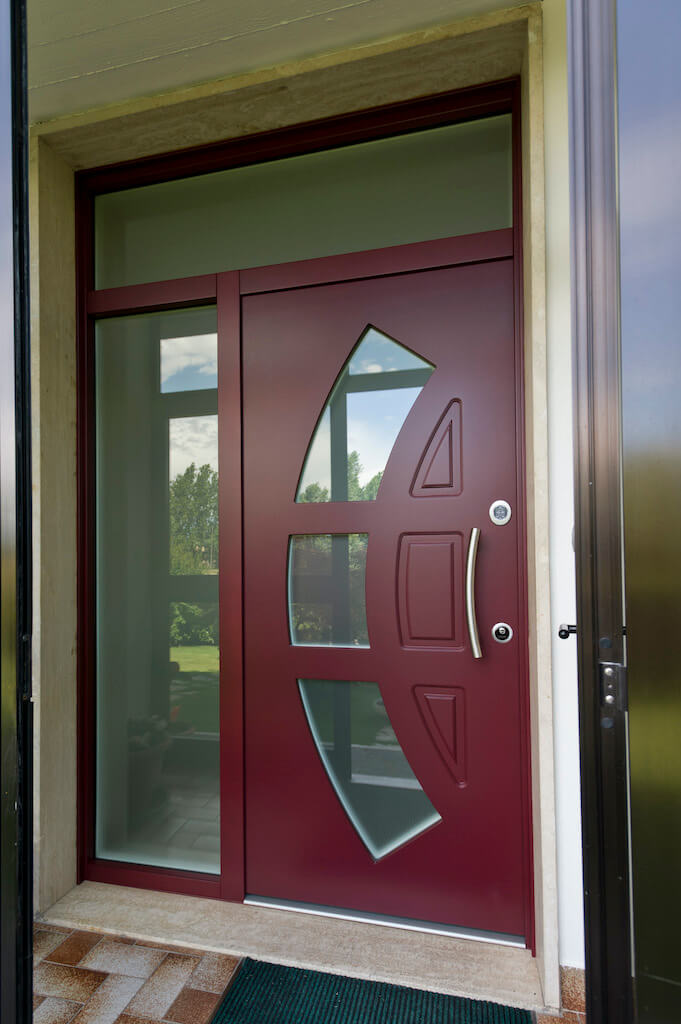 A photo of a security door made of glass and wood at the front entrance of a luxury home.